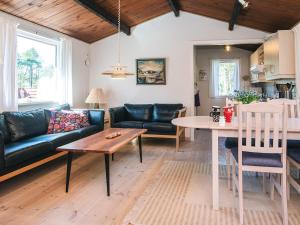 a living room with a couch and a table at 4 person holiday home in Thisted-By Traum in Thisted +20 photos