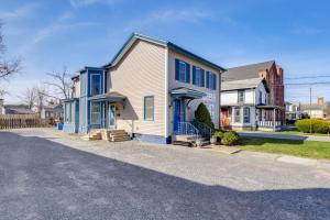 a white house with blue trim on a street at 1 Block to Dtwn Seneca Falls Apartment with Yard! in Seneca Falls