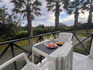 a table with a plate of food and a bottle of wine at Green Apartment 14 in Tavira Garden in Tavira