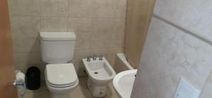 a bathroom with a toilet and a bidet and a sink at Centro in Neuquén