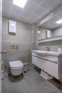 a bathroom with a toilet and a sink at Palladium Villa in Side