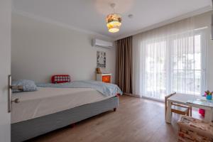 a bedroom with a bed and a large window at Palladium Villa in Side +30 photos