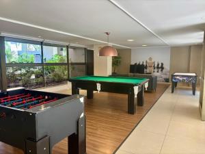 a billiard room with a pool table in the middle at Viva o Paraíso – Condomínio Exclusivo Beira-Mar e Lazer Completo in Ilha da Restinga