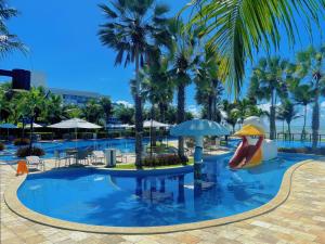 a large swimming pool with a slide and a slidesktop at Viva o Paraíso – Condomínio Exclusivo Beira-Mar e Lazer Completo in Ilha da Restinga