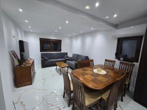 a living room with a table and a couch at Apartmani Mikić in Bosanski Šamac