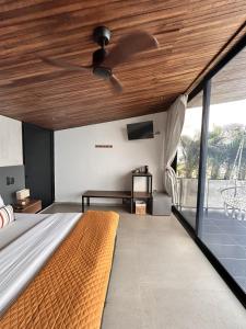 a bedroom with a bed with a wooden ceiling at Hotel Boutique el Fique in Los Santos +40 photos