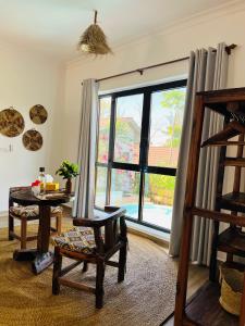 a living room with a large window and a chair at Z-Love Zanzibar in Kiwengwa