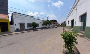 an empty street in a town with buildings at Casa Centrica in Yacuiba