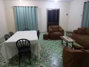 a living room with a table and chairs and a couch at Casa Centrica in Yacuiba