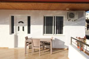 a patio with a table and chairs on a porch at Seaside Villa Genti Seaview in Ksamil