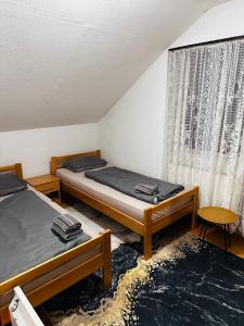 a room with two beds and a window at Apart Jajce in Jajce