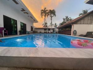 a swimming pool in the middle of a house at Jasmin Czechinn in Dauis