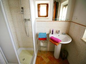 a bathroom with a sink and a shower at Cottage in Asciano with Pool and Terrace in Asciano +30 photos