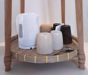 a shelf with three white appliances on it at Irmy's Village in Gili Islands