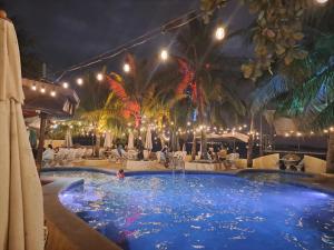 a swimming pool at a resort at night at Treasure Island Beach Resort in Olongapo