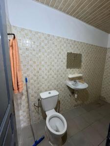 un baño con inodoro y lavabo en Le doux refuge, en Abiyán 1 foto más
