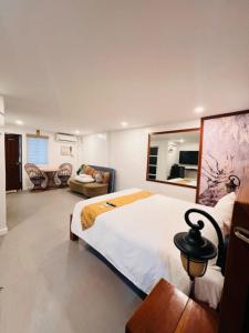 a bedroom with a large bed and a living room at Treasure Island Beach Resort in Olongapo +34 photos