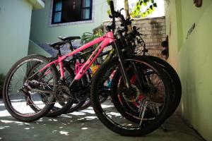 two bikes are parked next to a building at Hostel Casa Lion - Shared room in Búzios