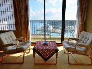two chairs and a table in a room with a large window at Kishotei - Vacation STAY 76550v in Hirado