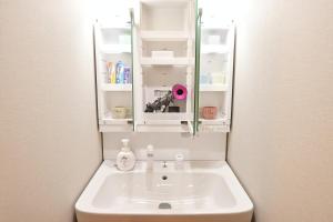 a bathroom sink with a mirror above it at Conveniently located for Tennoji Station, direct access to Kansai Airport, Japanese-style modern 3rooms, convenient shopping in Osaka +97 photos