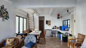 a room with a table and chairs and a kitchen at Inn the Mountain a farm house on a foggy farm hill in Cebu City +46 photos