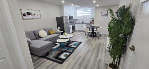 a living room with a couch and a table at Bleniel Place - Stylish Basement Suite with Wi-Fi Netflix & Parking in Edmonton