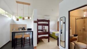 a room with a kitchen with a counter and a bathroom at Eco del Mar in La Libertad +129 photos