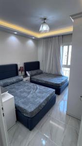 a living room with two beds and a couch at Amazing 3BHK Fully Furnished apt in Madinty New Cairo in Madinaty