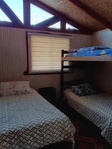 Ένα ή περισσότερα κρεβάτια σε δωμάτιο στο Brisas del llaima