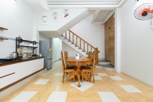a kitchen and dining room with a wooden table at Vicky's House- Balcony Room in Nha Trang