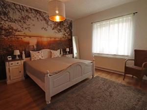 a bedroom with a large white bed and a window at Peaceful Hideaway in Gorow in Gorow
