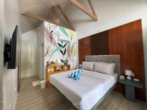 Del MonteWanderlust Resort Samal的卧室里有一张大床，上面放着蓝色枕头