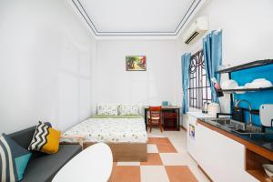 a small room with a bed and a table at Vicky's House- Back Room in Nha Trang