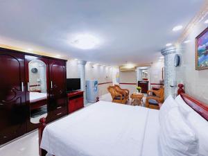 a hotel room with a bed and a living room at K&T Hotel - Center SaiGon in Ho Chi Minh City