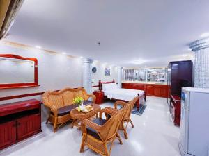 a living room with a bed and a table and chairs at K&T Hotel - Center SaiGon in Ho Chi Minh City