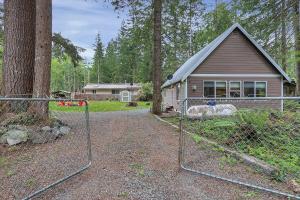 a house with a gate in front of a house at Luxury Rainier Cabin-Sauna-Hot Tub-EV-WiFi in Ashford