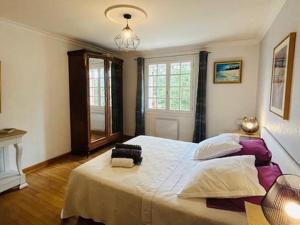 a bedroom with a large white bed with a window at Maison de charme avec piscine privée, salle de sport proche de Bergerac et Périgueux - FR-1-616-132 in Villamblard +16 photos