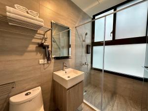 a bathroom with a toilet and a sink and a shower at Neostay in Zhubei