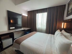Кровать или кровати в номере Dreamtel Kota Kinabalu