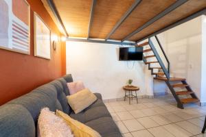 a living room with a couch and a tv at Best Location in Sayulita - Walk to Everything in Sayulita