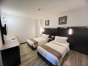 Postel nebo postele na pokoji v ubytování Dreamtel Kota Kinabalu