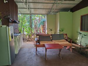 a living room with a couch and a table at Ana Paraíso entre Arboles in Drake