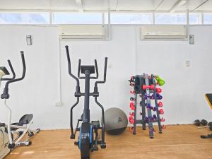 a gym with treadmills and exercise bikes in a room at MK Residence JVC in Dubai