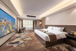 Voodi või voodid majutusasutuse Foshan Zhongying Holiday Hotel toas