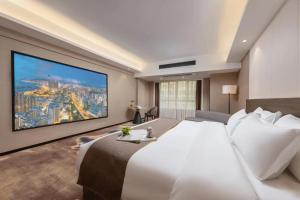 Voodi või voodid majutusasutuse Foshan Zhongying Holiday Hotel toas