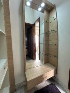 a dressing room mirror with a wooden dresser at Nova Villa with Patio Escape in Amritsar +30 photos