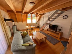 a living room with a couch and a table at Ferienwohnung-Blume DG in Wolfach