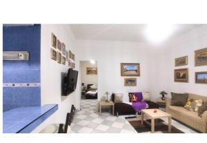 a living room with a couch and a tv at Entire accommodation Departamento Mi Mexico in Mexico City