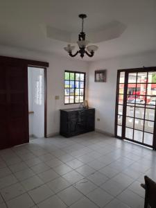 a living room with a ceiling fan and a table at Casa Margarita in Santiago