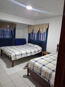 Postel nebo postele na pokoji v ubytování Casa Margarita
